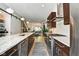Large kitchen with eat in island, stainless steel appliances, brown cabinets and open floor plan at 1311 Central Ave, Indianapolis, IN 46202