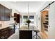 Contemporary kitchen featuring an island with bar seating, stainless steel appliances, and a pantry at 1311 Central Ave, Indianapolis, IN 46202