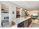 Modern kitchen with granite island, stainless steel dishwasher, and a sliding barn door pantry at 1311 Central Ave, Indianapolis, IN 46202