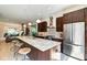 Open-concept kitchen featuring stainless appliances, eat-in island, and views of the living area at 1311 Central Ave, Indianapolis, IN 46202