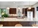 Spacious kitchen showcasing a granite island, stainless steel appliances, and modern pendant lighting at 1311 Central Ave, Indianapolis, IN 46202