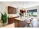 Modern kitchen featuring brown cabinets, granite counters, a large island and stainless appliances at 1311 Central Ave, Indianapolis, IN 46202