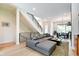 Bright living room features a staircase with black metal railing, large sofa and open floor plan at 1311 Central Ave, Indianapolis, IN 46202