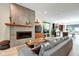 Open-concept living room featuring a modern fireplace, hardwood floors, and an eat-in kitchen at 1311 Central Ave, Indianapolis, IN 46202