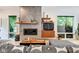 Bright living room with contemporary fireplace, hardwood floors, and many windows for natural light at 1311 Central Ave, Indianapolis, IN 46202