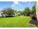 Spacious backyard with a lush lawn, mature trees, and a charming patio, perfect for outdoor gatherings at 13264 Penneagle Dr, Carmel, IN 46033
