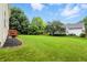Expansive backyard featuring lush green lawn and mature trees, offering privacy and space at 13264 Penneagle Dr, Carmel, IN 46033