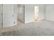 A bedroom with carpet and white walls features a walk-in closet and hallway access at 13264 Penneagle Dr, Carmel, IN 46033