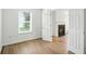A neutral-colored bedroom featuring hardwood floors with a view to the living room at 13264 Penneagle Dr, Carmel, IN 46033
