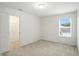 Bright bedroom features a window offering natural light, neutral carpet, and walk-in closet at 13264 Penneagle Dr, Carmel, IN 46033