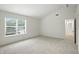 Bright bedroom features a large window offering natural light and neutral carpet at 13264 Penneagle Dr, Carmel, IN 46033
