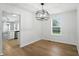 Dining area with hardwood floors, modern lighting, and view of kitchen at 13264 Penneagle Dr, Carmel, IN 46033