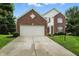 Charming two-story home features a brick facade, attached garage, and well-maintained lawn at 13264 Penneagle Dr, Carmel, IN 46033