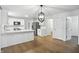 Bright, modern kitchen with stainless steel appliances, white cabinets, and stylish light fixture at 13264 Penneagle Dr, Carmel, IN 46033