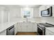 Modern kitchen with white cabinets, stainless steel appliances, and quartz countertops at 13264 Penneagle Dr, Carmel, IN 46033