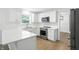 Modern kitchen with white cabinets, stainless steel appliances, and quartz countertops at 13264 Penneagle Dr, Carmel, IN 46033