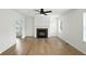 A spacious living room is bright with a fireplace, ceiling fan and light wood floors at 13264 Penneagle Dr, Carmel, IN 46033