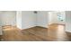 Open-concept living room with hardwood floors, white walls, and adjacent staircase at 13264 Penneagle Dr, Carmel, IN 46033