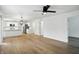 An open concept living room and kitchen with wood floors and a view to a hallway at 13264 Penneagle Dr, Carmel, IN 46033