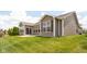 A spacious backyard view showing a green lawn, landscaping, and rear exterior at 1418 Blackthorne S Trl, Plainfield, IN 46168