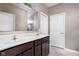A bright bathroom features a double sink vanity with dark wood cabinets and a large mirror above at 1418 Blackthorne S Trl, Plainfield, IN 46168