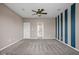 Spacious bedroom features a ceiling fan, neutral carpeting, a doorway to another room, and blue striped accent wall at 1418 Blackthorne S Trl, Plainfield, IN 46168