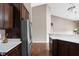 Open kitchen layout with stainless steel refrigerator and spacious countertops at 1418 Blackthorne S Trl, Plainfield, IN 46168