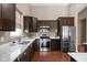 Modern kitchen features stainless steel appliances, quartz countertops, and dark wood cabinets at 1418 Blackthorne S Trl, Plainfield, IN 46168