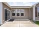 A cozy patio area with sliding glass doors, three windows, and brown siding at 1418 Blackthorne S Trl, Plainfield, IN 46168
