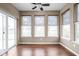 A sun room offers a sliding glass door, hardwood floors, and a view of the backyard pond at 1418 Blackthorne S Trl, Plainfield, IN 46168
