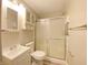 Bathroom features a vanity with a sink, a toilet, and a shower with sliding glass doors at 1605 S Leland Ave, Indianapolis, IN 46203