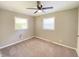 Serene bedroom with carpeted floors, neutral paint and an overhead ceiling fan with light coming in from two windows at 1605 S Leland Ave, Indianapolis, IN 46203