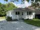 Charming single-story home with gravel driveway and a cozy front porch, perfect for relaxing outdoors at 1605 S Leland Ave, Indianapolis, IN 46203