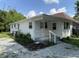 Quaint single-story home featuring a covered front porch and a tidy, low-maintenance gravel front yard at 1605 S Leland Ave, Indianapolis, IN 46203