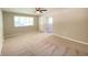 Bright, carpeted living room with a large window and neutral walls, perfect for comfortable living and entertaining at 1605 S Leland Ave, Indianapolis, IN 46203