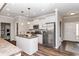 Bright kitchen with stainless steel appliances, center island, and wood flooring at 164 Luna Pl, Shelbyville, IN 46176