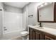 A well-lit bathroom featuring a shower-tub combo, modern vanity, and classic fixtures at 1657 Park Terrace Ct, Indianapolis, IN 46229