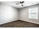 A cozy bedroom with plush carpeting, a ceiling fan and a window with natural light at 1657 Park Terrace Ct, Indianapolis, IN 46229