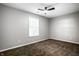 A bright bedroom with neutral walls, soft carpeting, and a window offering outdoor views at 1657 Park Terrace Ct, Indianapolis, IN 46229