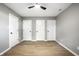 Bedroom featuring stylish floors, a neutral color palette, and three closet doors at 1657 Park Terrace Ct, Indianapolis, IN 46229