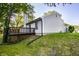 Charming home featuring a side deck, vinyl siding, a manicured lawn, and mature shade trees at 1657 Park Terrace Ct, Indianapolis, IN 46229