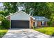 Charming single-story home with brick accents, lush lawn, mature trees, and a convenient two-car garage at 1657 Park Terrace Ct, Indianapolis, IN 46229