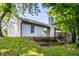 This charming home features a brick foundation, vinyl siding, a manicured lawn, and mature shade trees at 1657 Park Terrace Ct, Indianapolis, IN 46229