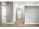 A well-lit foyer features neutral paint, wood floors, a pendant light, and interior door access at 1657 Park Terrace Ct, Indianapolis, IN 46229