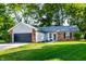 Charming single-story home with brick accents, lush lawn, mature trees, and a convenient two-car garage at 1657 Park Terrace Ct, Indianapolis, IN 46229