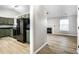 An eat-in kitchen featuring modern appliances, painted cabinets, laminate floors, and an open view of the living room at 1657 Park Terrace Ct, Indianapolis, IN 46229