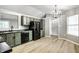 Bright, open eat-in kitchen with green cabinets, modern appliances, and sleek black refrigerator at 1657 Park Terrace Ct, Indianapolis, IN 46229
