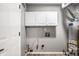 A functional laundry room featuring white cabinets, modern appliances, and efficient layout at 1657 Park Terrace Ct, Indianapolis, IN 46229