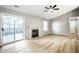 Sunlit living room with stylish floors, a cozy fireplace, and sliding door access to the patio at 1657 Park Terrace Ct, Indianapolis, IN 46229