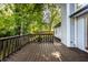 A large wood deck with railing offers views of the green lush back yard and trees at 1657 Park Terrace Ct, Indianapolis, IN 46229
